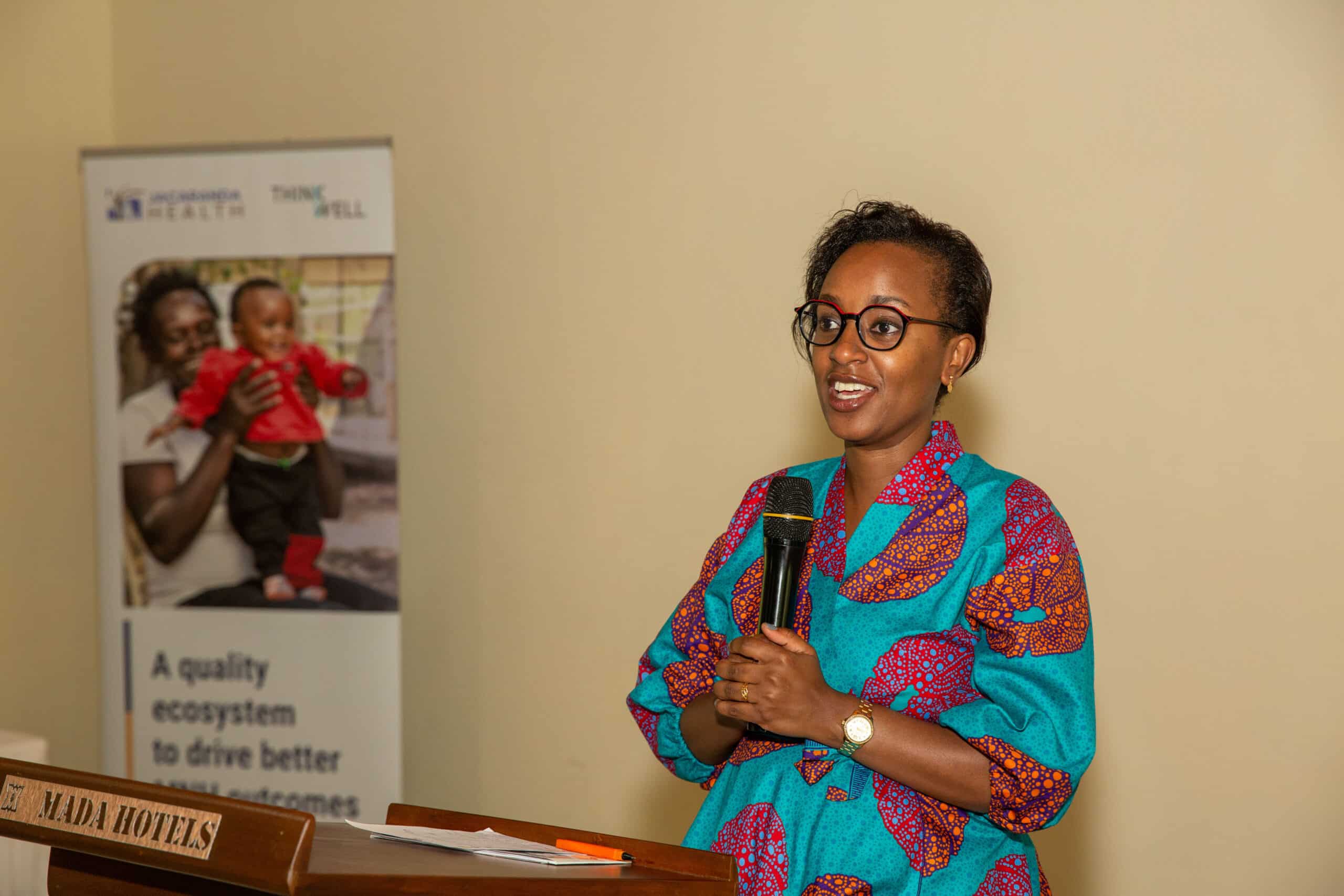 Cynthia Kahumbura giving a speech at the Kenya Quality Ecosystem County Cross-Learning in Makueni County.